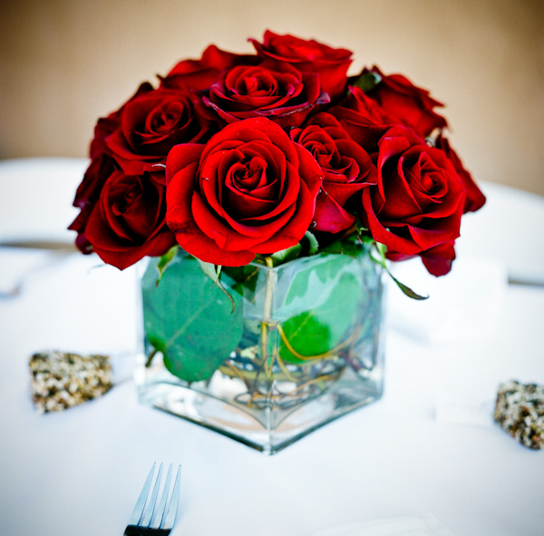 photo of centerpiece of red roses in a square transparent vase - photo by New Mexico based wedding photographers Twin Lens